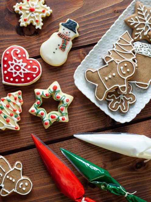 Biscotti di Natale decorati con ghiaccia reale a forma di pupazzo di neve, cuore, stella e omino di pan di zenzero