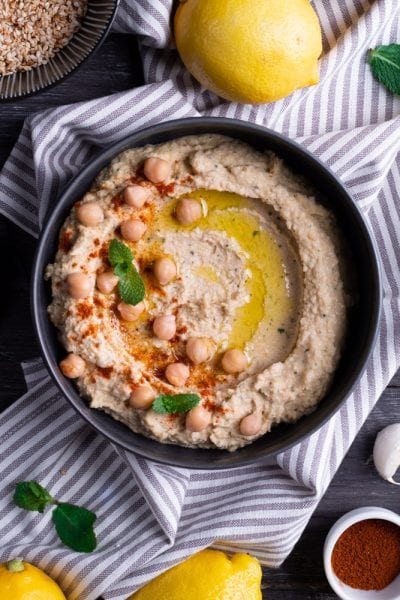 Hummus cremoso con ceci, olio d'oliva, paprika e foglie di menta fresca