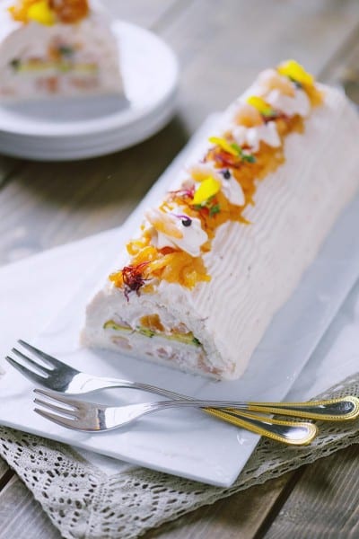 Tronchetto salato farcito con crema, frutta candita e petali di fiori eduli sulla sommità