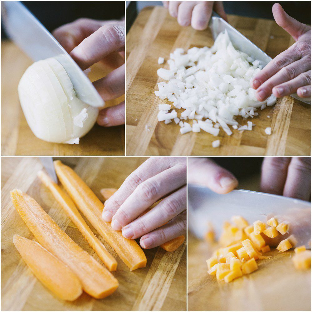 Cipolla tritata finemente e carota tagliata a cubetti sul tagliere