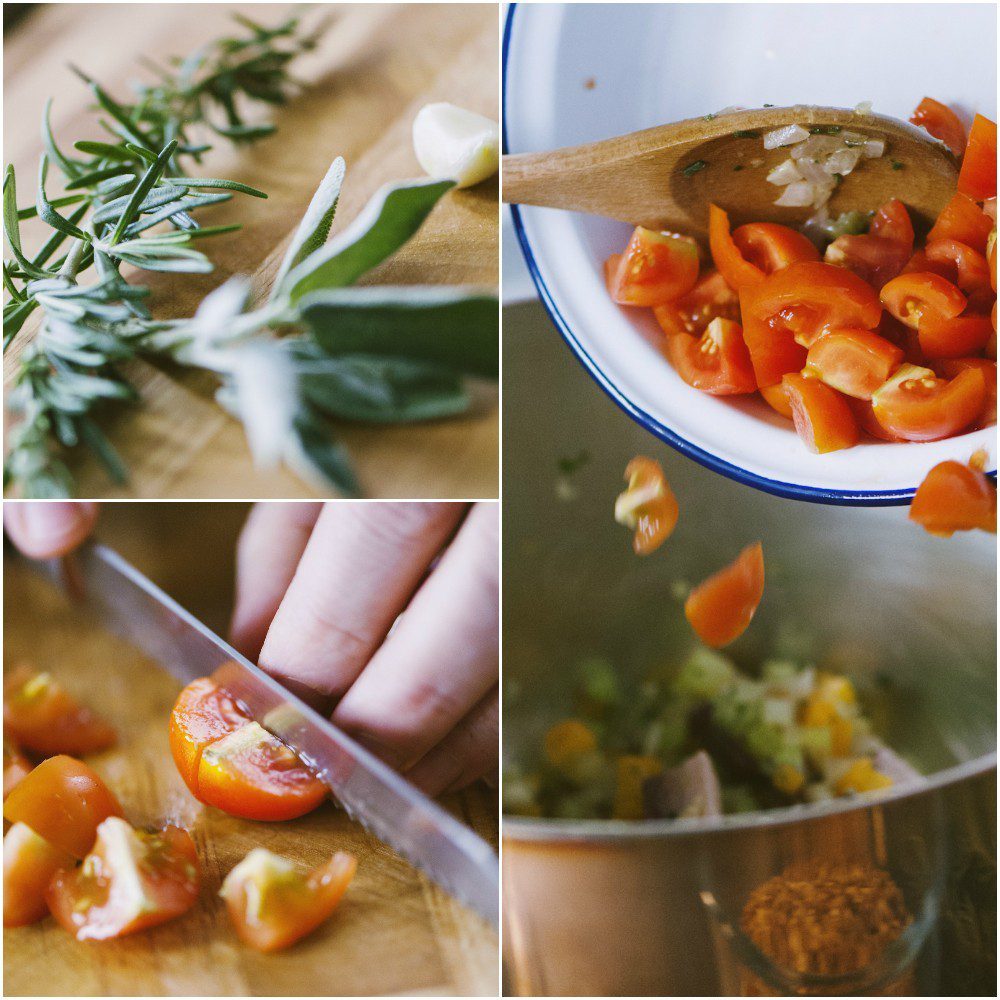 Pomodorini tagliati a pezzi versati in pentola con il soffritto, rosmarino e salvia sul tagliere