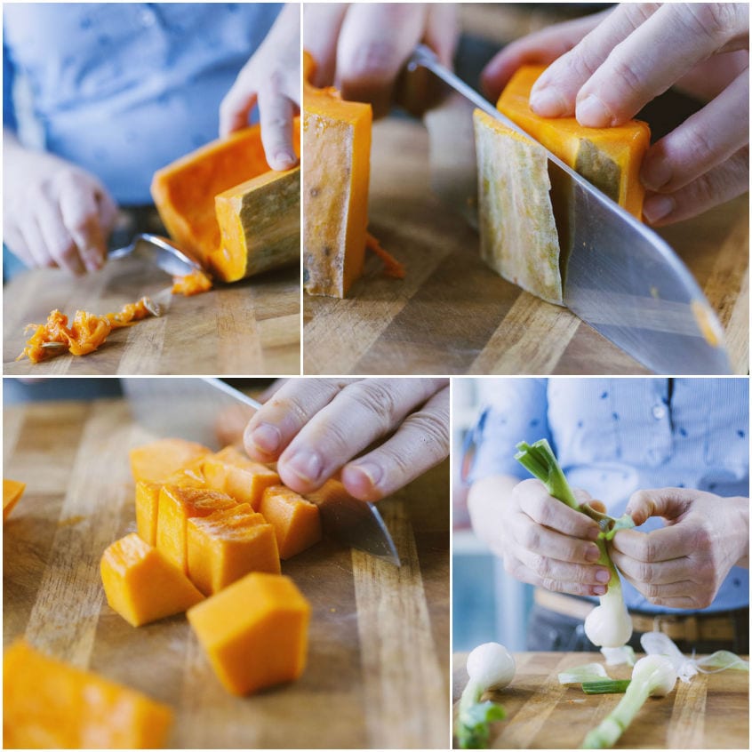 Zucca butternut tagliata a cubotti sul tagliere e pulizia del porro