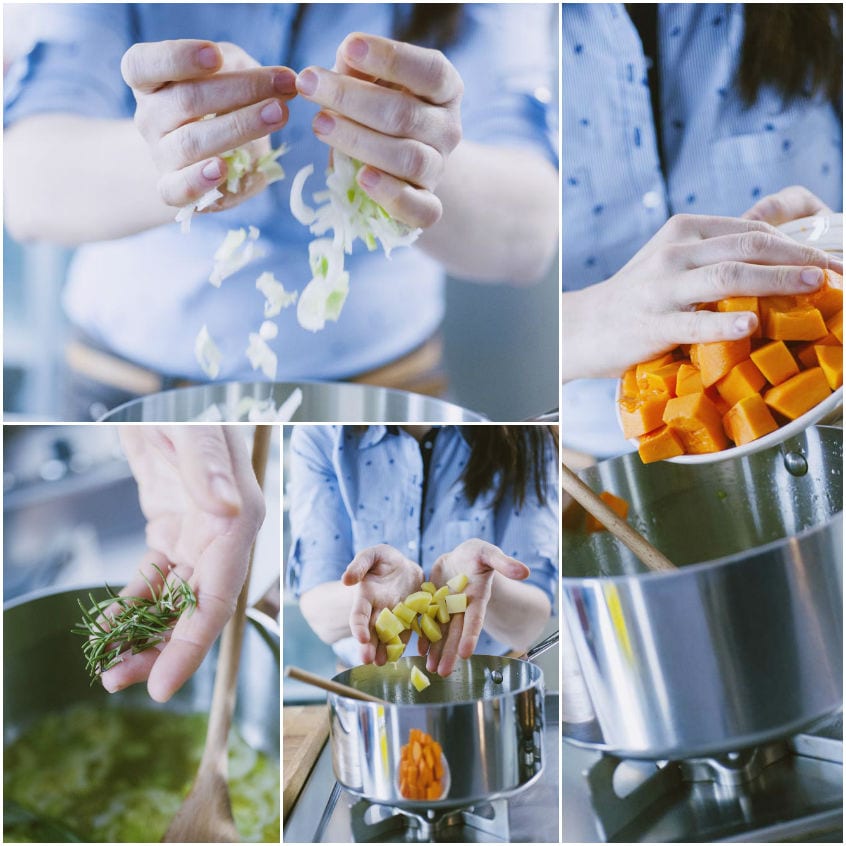 Mani che aggiungono in pentola porri, zucca a cubetti, patate e rosmarino per la zuppa