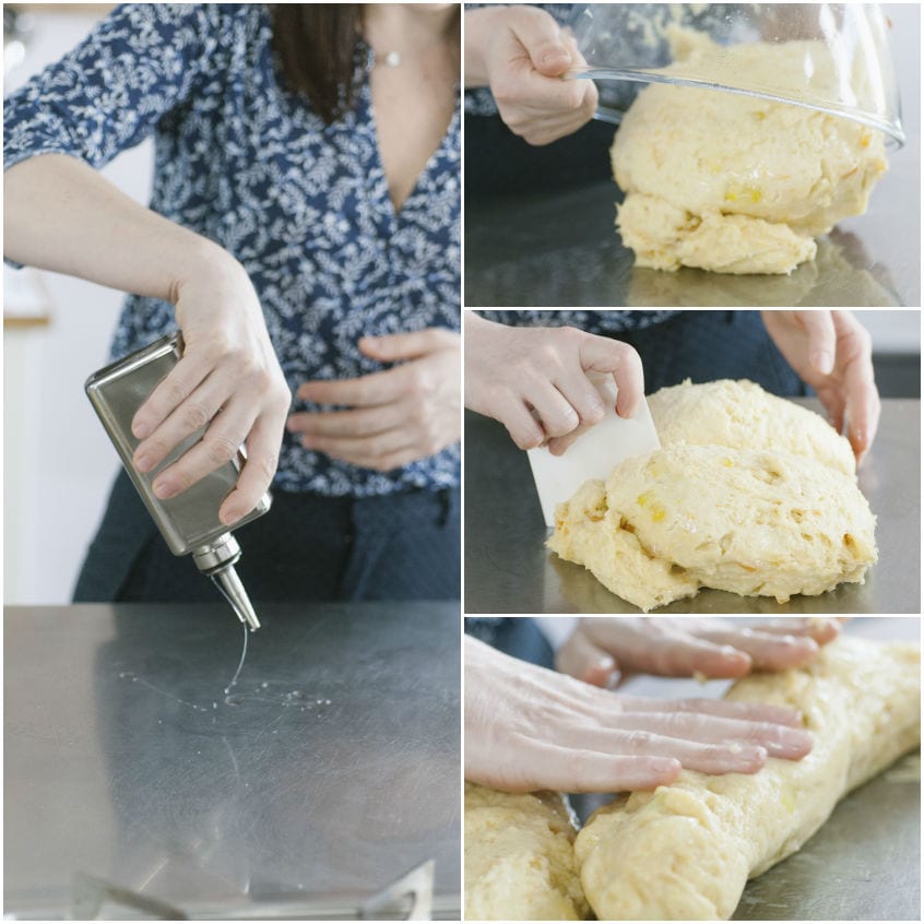 Mani che lavorano l'impasto della colomba senza glutine sul piano oliato, formando un filoncino