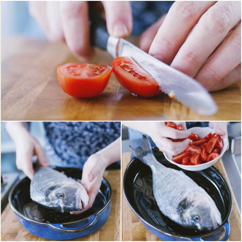 Pomodoro tagliato a metà e orata sistemata in teglia con pomodorini a pezzi
