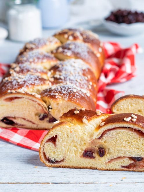 Treccia ai frutti rossi affettata con ripieno di uvetta e confettura, granella di zucchero in superficie