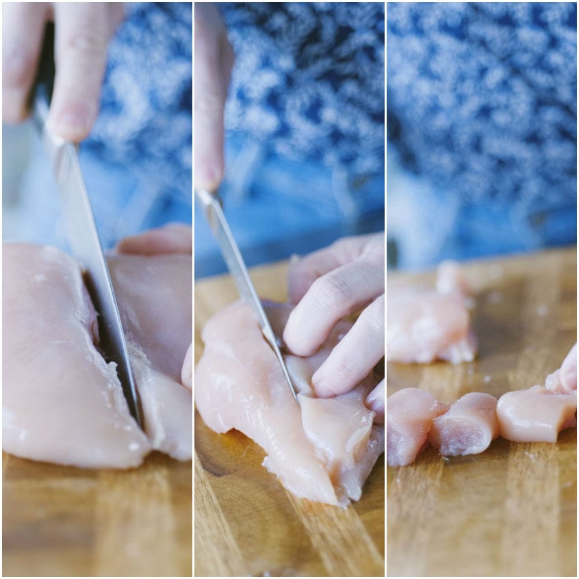 Petto di pollo tagliato a metà, poi a fette e infine a cubotti pronti per gli spiedini