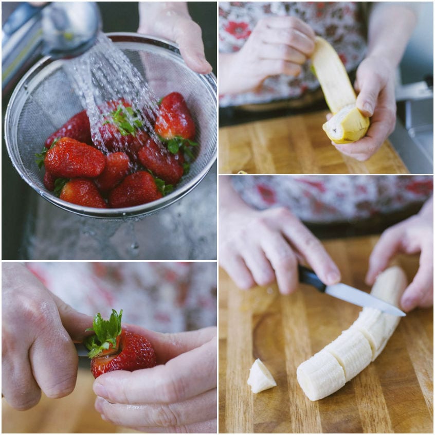 Fragole lavate sotto l'acqua corrente, banana sbucciata e tagliata a rondelle sul tagliere