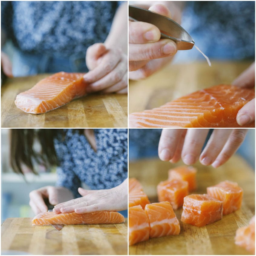 Filetto di salmone privato della pelle e tagliato a cubotti sul tagliere