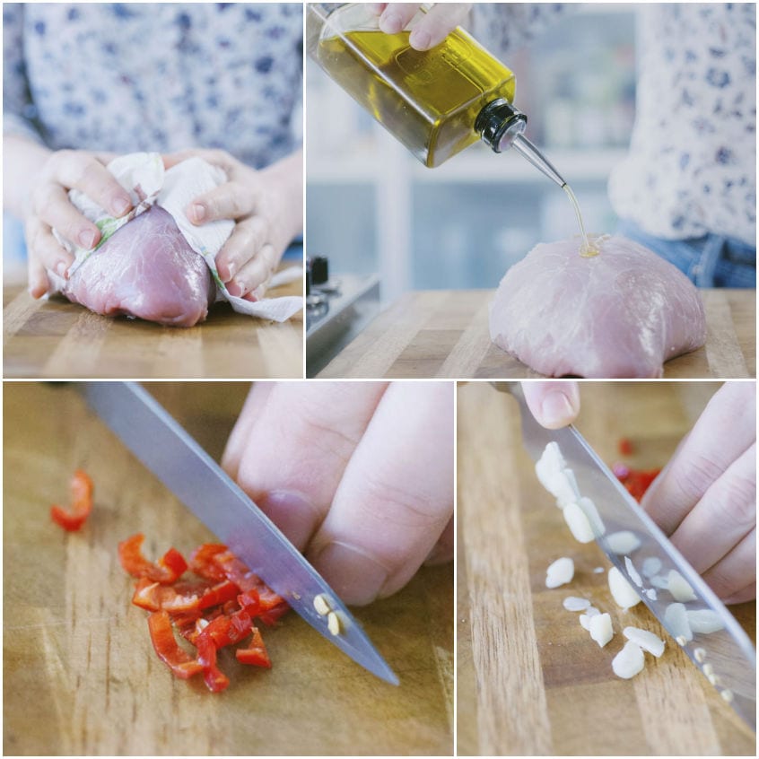 Preparazione dell'arrosto di vitello: asciugatura della carne, olio versato, peperoncino e aglio tritati sul tagliere