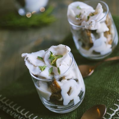 Boccon du diable servito in bicchiere con crema bianca, pezzi di pane e foglioline di timo fresco