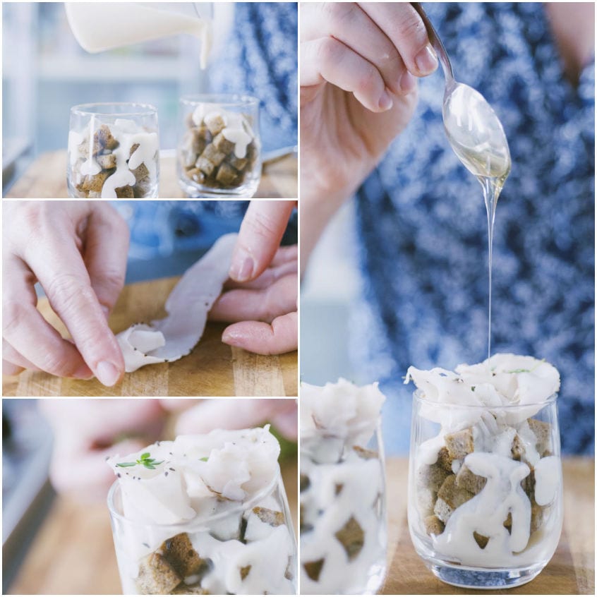 Bicchieri assemblati con crostini di segale, fonduta e lardo, rifiniti con un filo di miele versato dal cucchiaio
