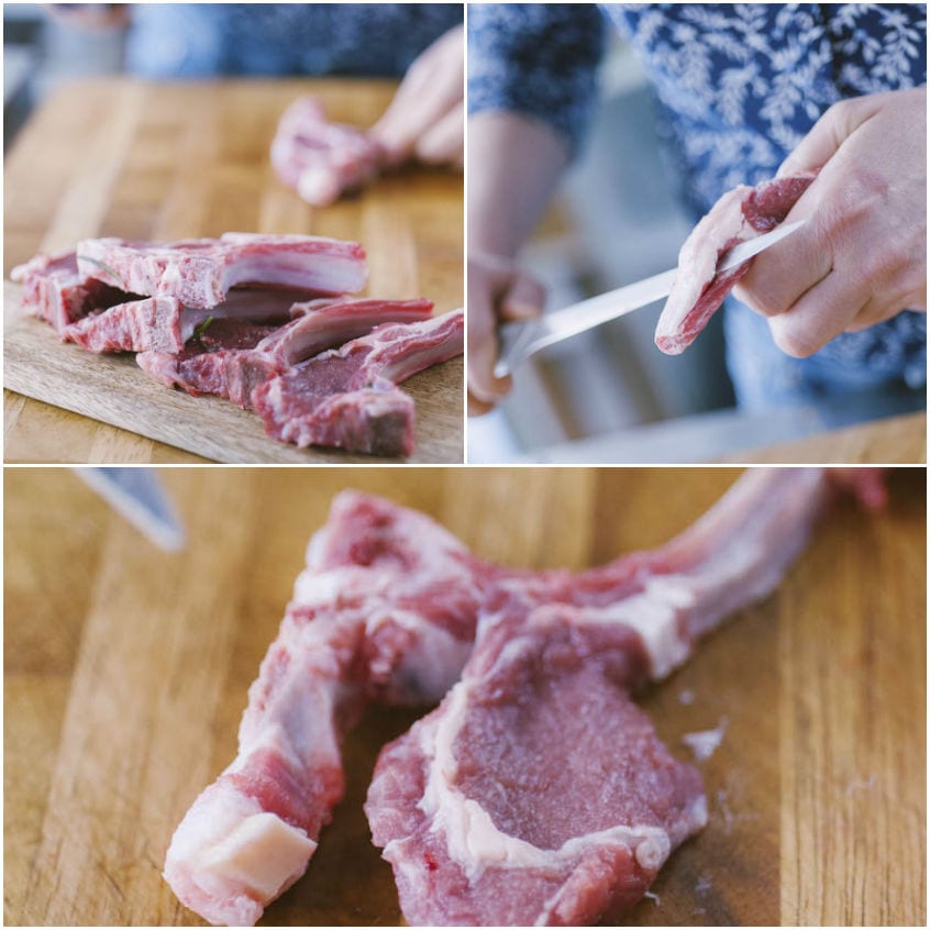Mani che puliscono costolette d'agnello crude esponendo l'osso sul tagliere