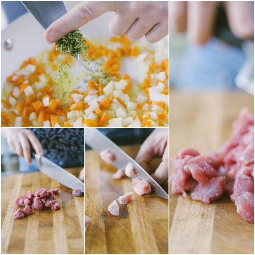 Soffritto di carota e cipolla con erbe tritate e carne mista tagliata a cubetti sul tagliere