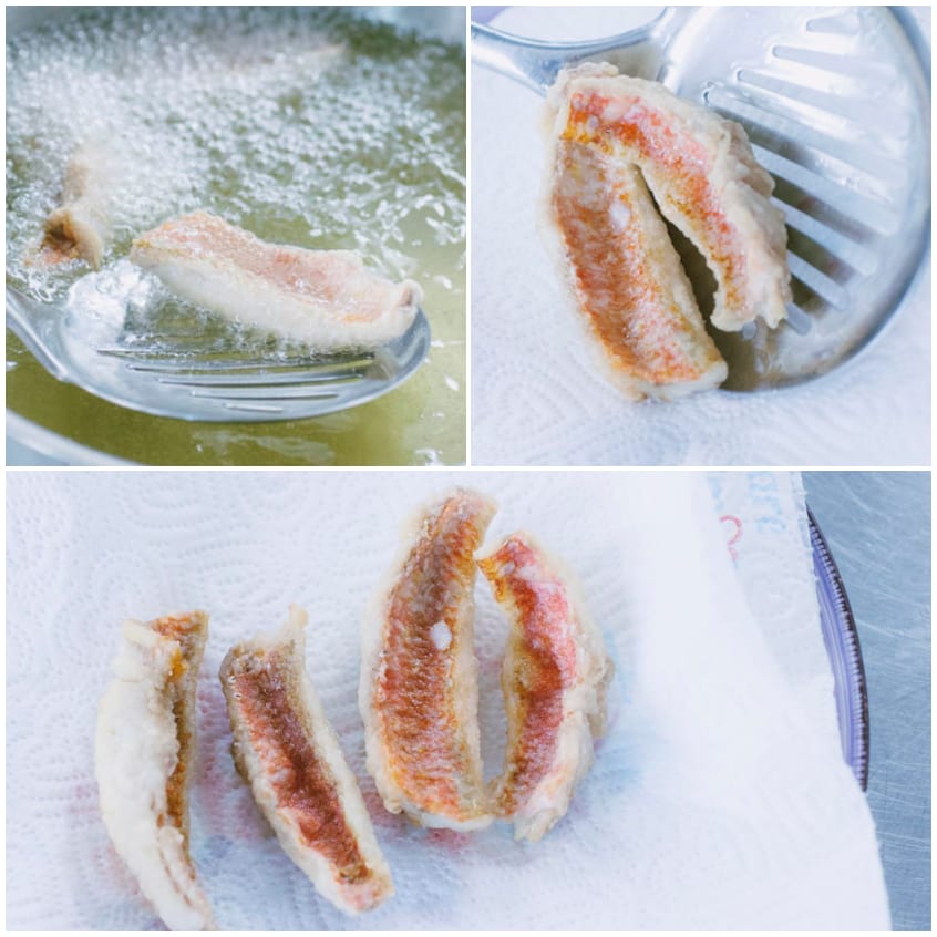 Filetti di triglia fritti nell'olio bollente, scolati e adagiati su carta assorbente