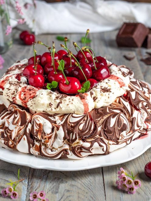 Pavlova foresta nera con meringa marmorizzata al cioccolato, panna montata e ciliegie fresche