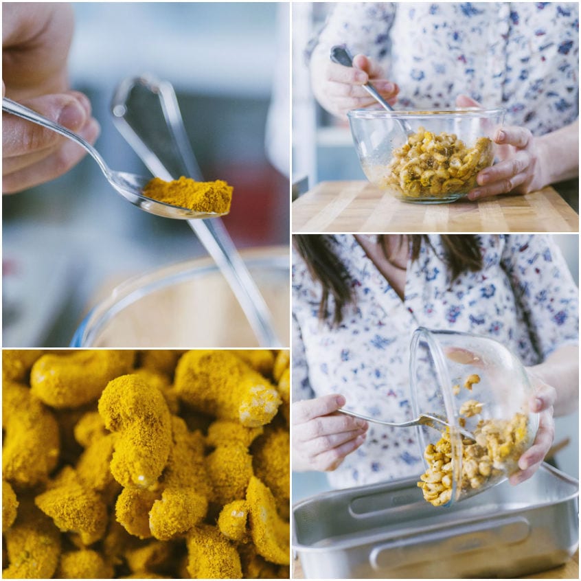 Anacardi cosparsi di curcuma mescolati in una ciotola prima di essere versati sulla teglia