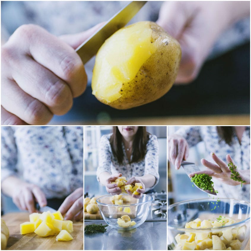 Patate lesse sbucciate, tagliate a tocchetti e raccolte in ciotola con erba cipollina tritata