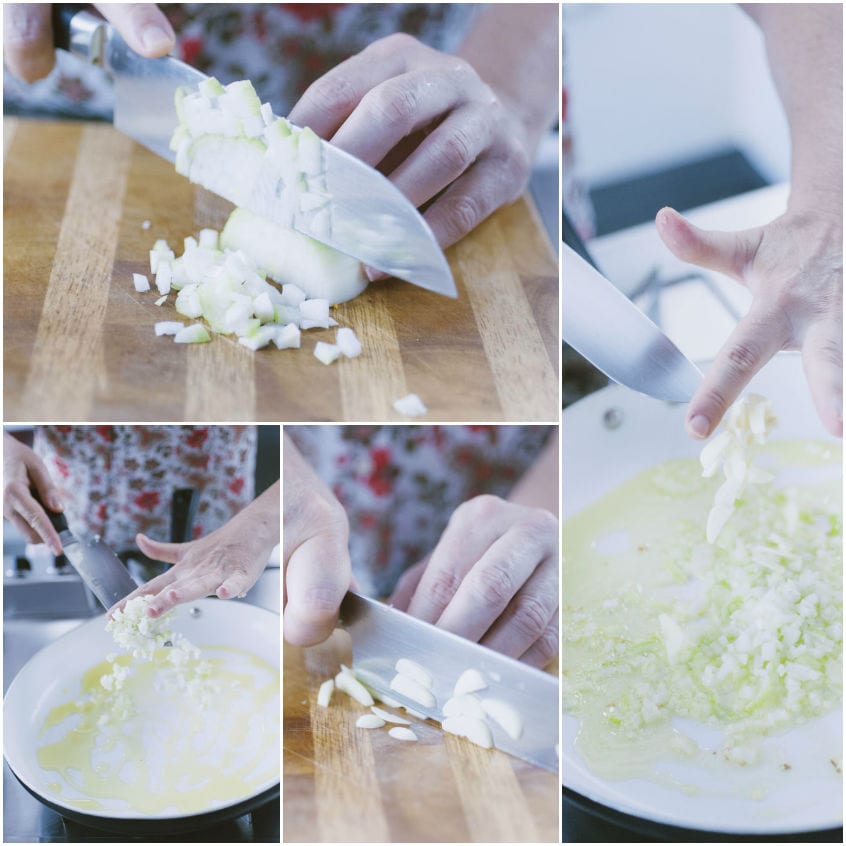 Cipolla tritata sul tagliere e aglio affettato che vengono aggiunti in padella con olio