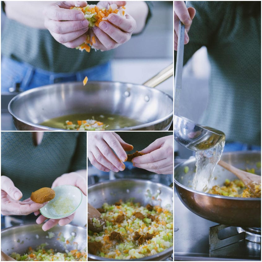 Sedano, carote e cipolla soffriggono in padella mentre si aggiunge pasta di curry e un mestolo di brodo