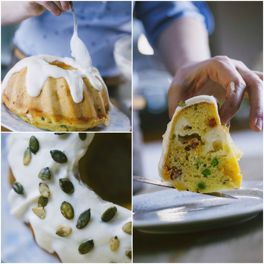 Kugelhopf salato ricoperto di crema di formaggio e semi di zucca, con una fetta tagliata che mostra piselli e pancetta
