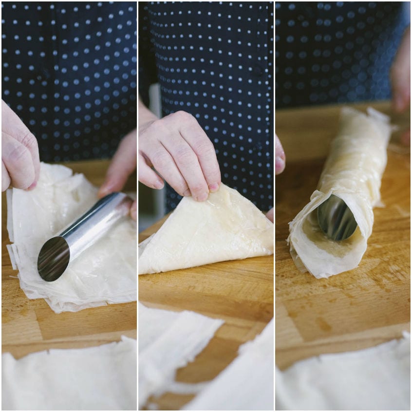 Sfoglia di pasta fillo avvolta attorno a un cilindro metallico per formare i cannoli