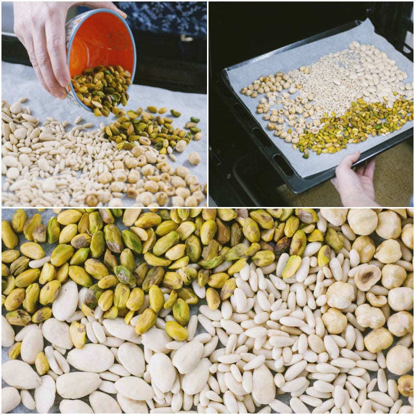 Pistacchi, mandorle e nocciole divisi per varietà pronti per la tostatura in forno su teglia
