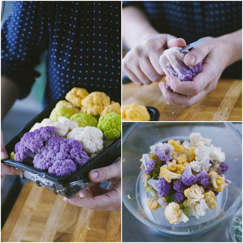 Cimette di cavolfiore viola, giallo, verde e bianco separate a mano sul tagliere