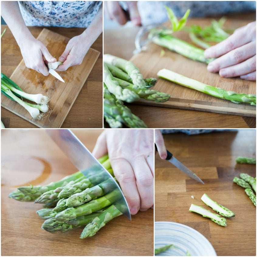 Mani mondano cipollotti e asparagi, pelando i gambi e tagliando le punte sul tagliere