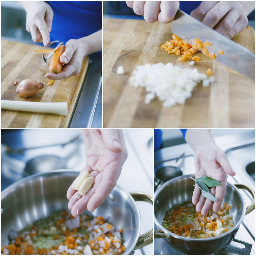 Carota e cipolla tagliate a cubetti, poi aglio e alloro versati nel soffritto in pentola