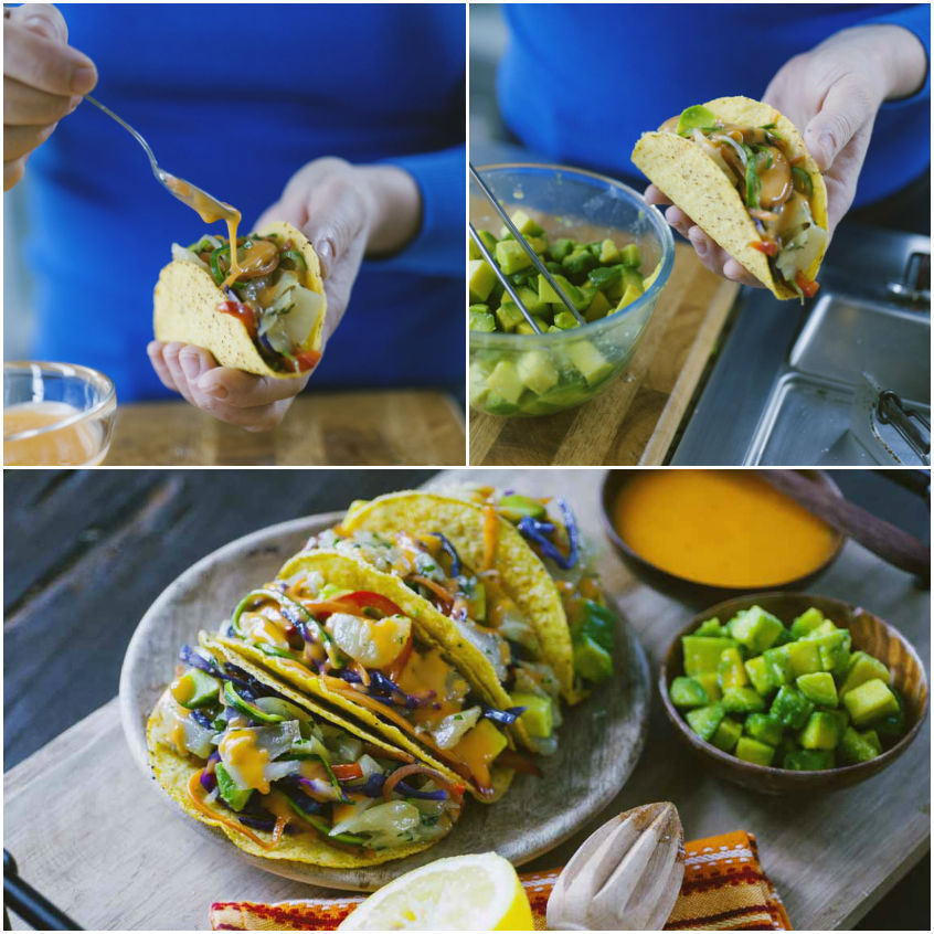 Taco farcito di verdure colorate condito con salsa arancione a filo prima di aggiungere l'avocado