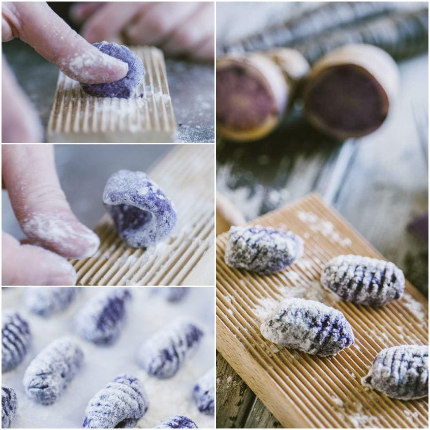 Mani che rigano gnocchi viola sul rigagnocchi, poi disposti infarinati sul vassoio