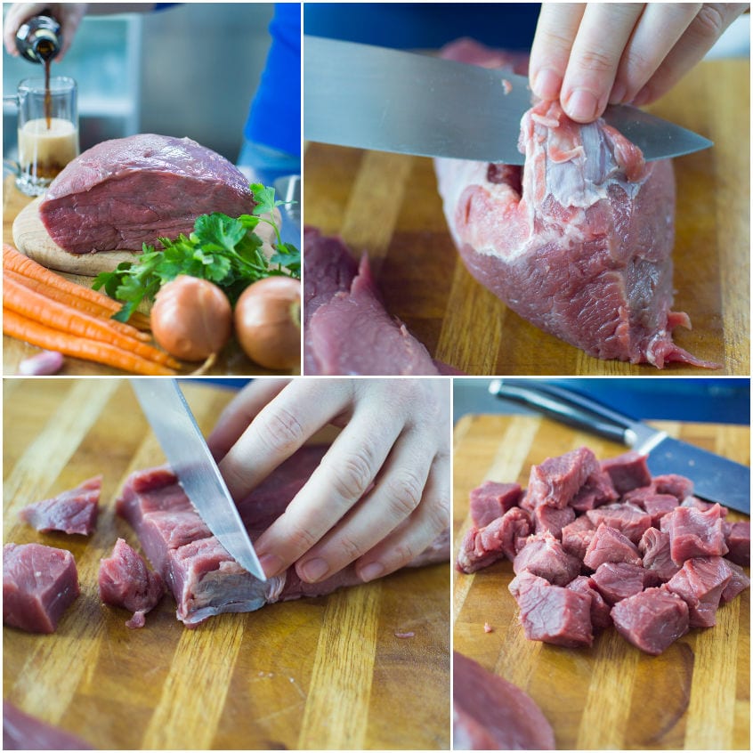 Carne cruda pulita dalle cartilagini e tagliata a cubetti sul tagliere