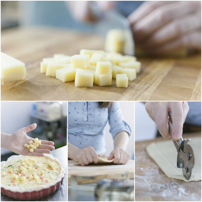 Formaggio tagliato a cubetti versato sulle verdure nella base di pasta brisé prima della cottura