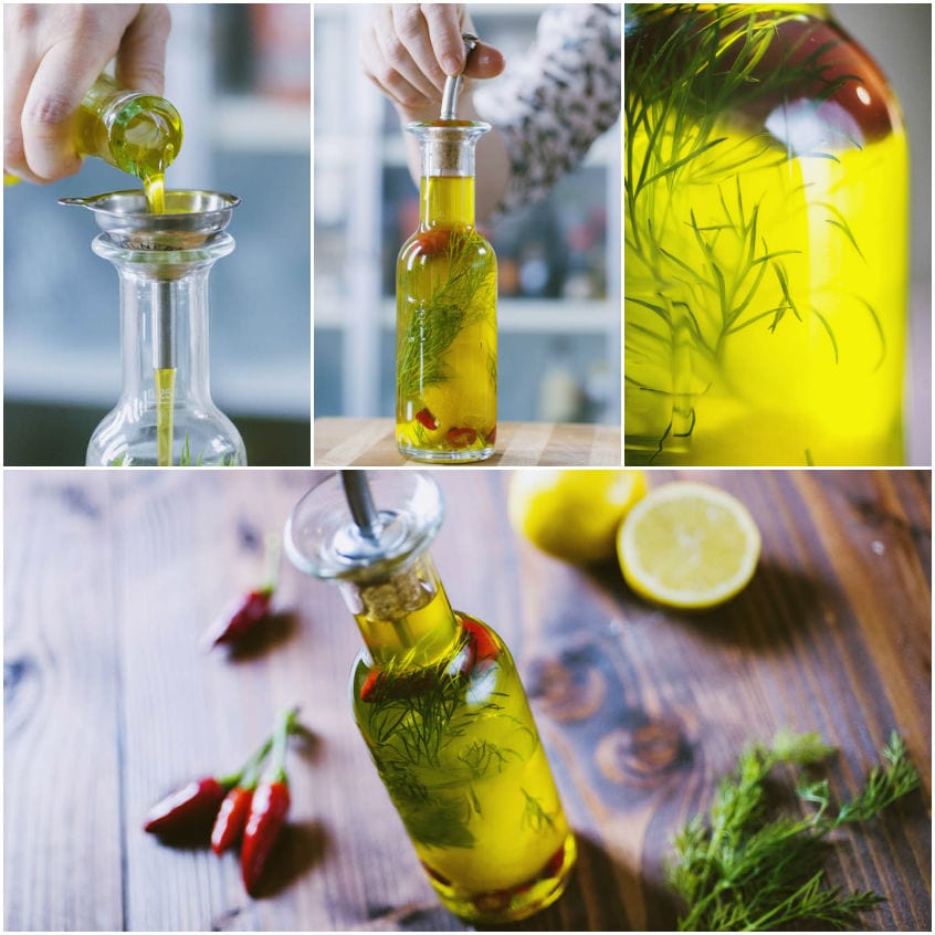 Olio aromatizzato versato in una bottiglia con aneto fresco e peperoncini rossi