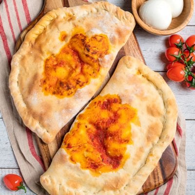 Calzone al forno con sugo di pomodoro e formaggio filante, appena sfornato