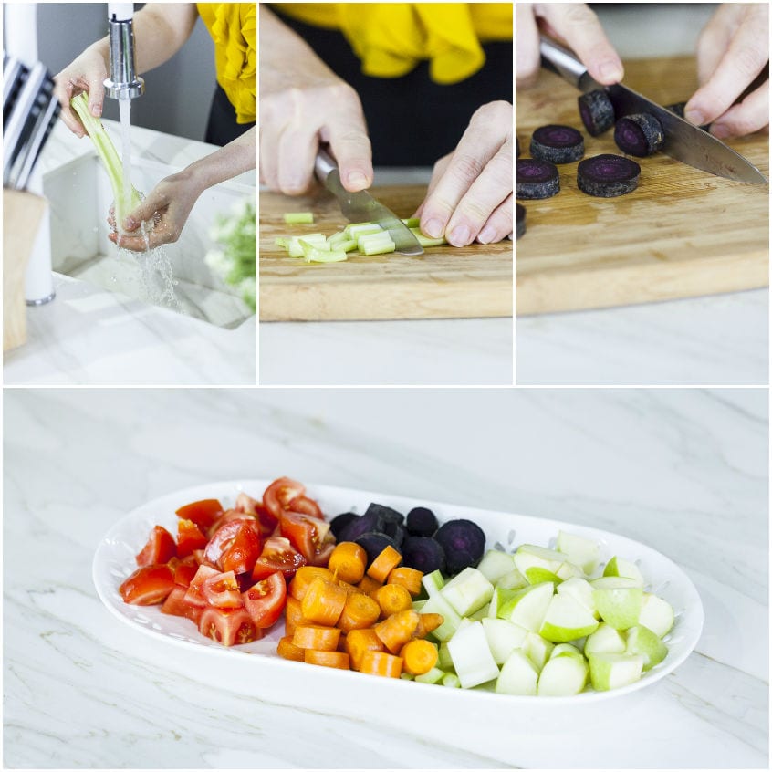 Verdure tagliate a pezzi disposte in sequenza: pomodori, carote, barbabietole viola, sedano e mela verde