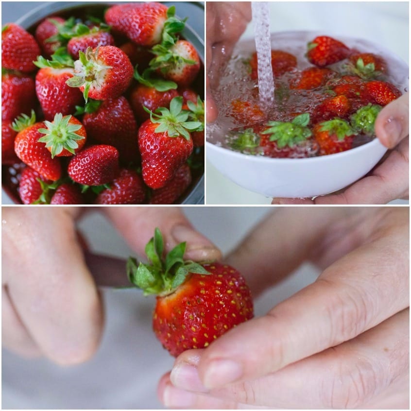 Fragole fresche raccolte, risciacquate sotto l'acqua corrente e private del picciolo a mano