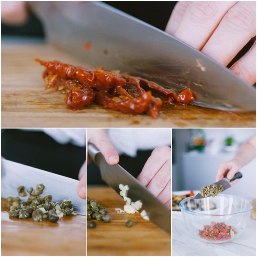 Tritatura di pomodori secchi, capperi e aglio sul tagliere, poi uniti in una ciotola