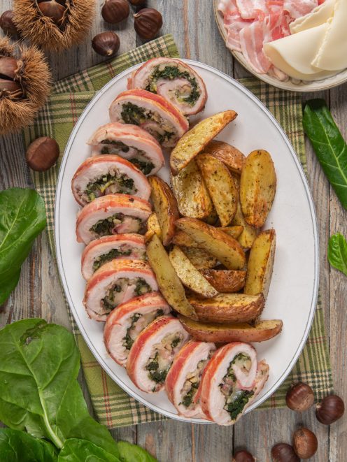 Rollè di pollo con castagne e bacon affettato, con ripieno di spinaci e castagne, servito con patate al forno