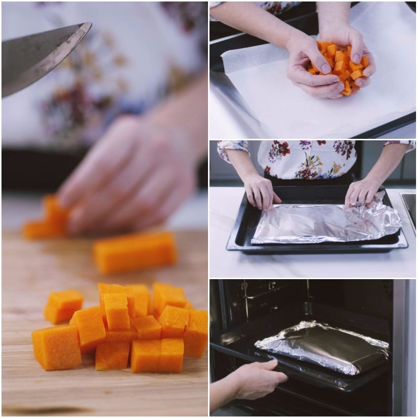 Cubetti di zucca tagliati a mano, disposti su carta forno e avvolti in alluminio prima di cuocere in forno