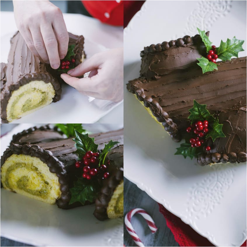 Mani che posizionano decorazioni di agrifoglio sul tronchetto di Natale ricoperto di ganache al cioccolato