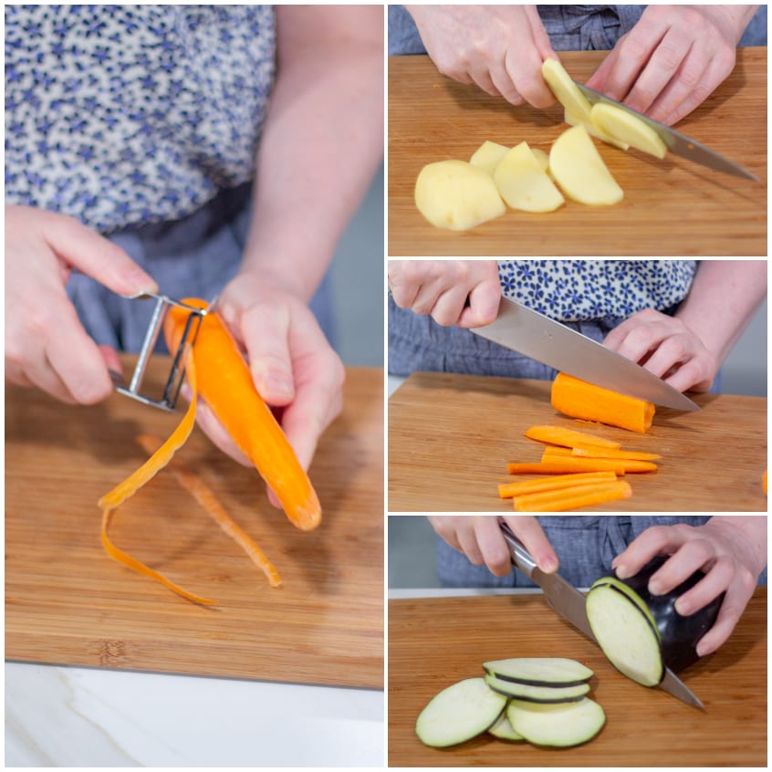 Verdure preparate sul tagliere: carota pelata, bastoncini di carota, fette di melanzana e patata a pezzi