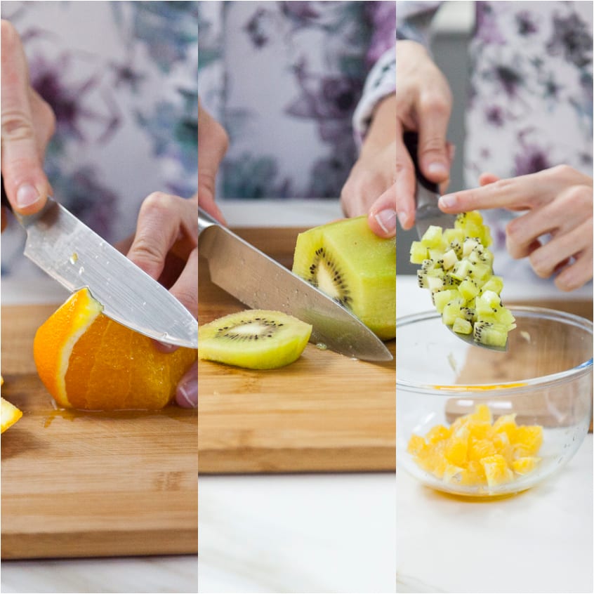 Arancia e kiwi tagliati a cubetti sul tagliere, poi versati in una ciotola per la decorazione