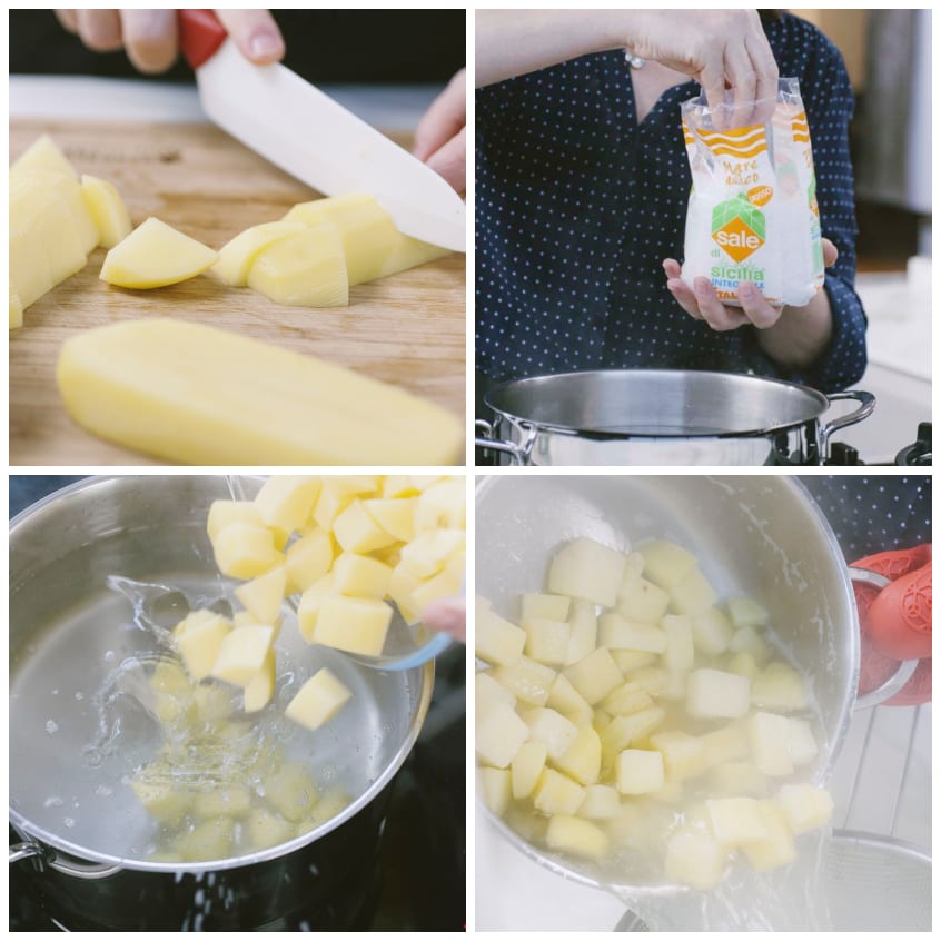 Patate tagliate a tocchetti sul tagliere, poi tuffate in acqua bollente salata