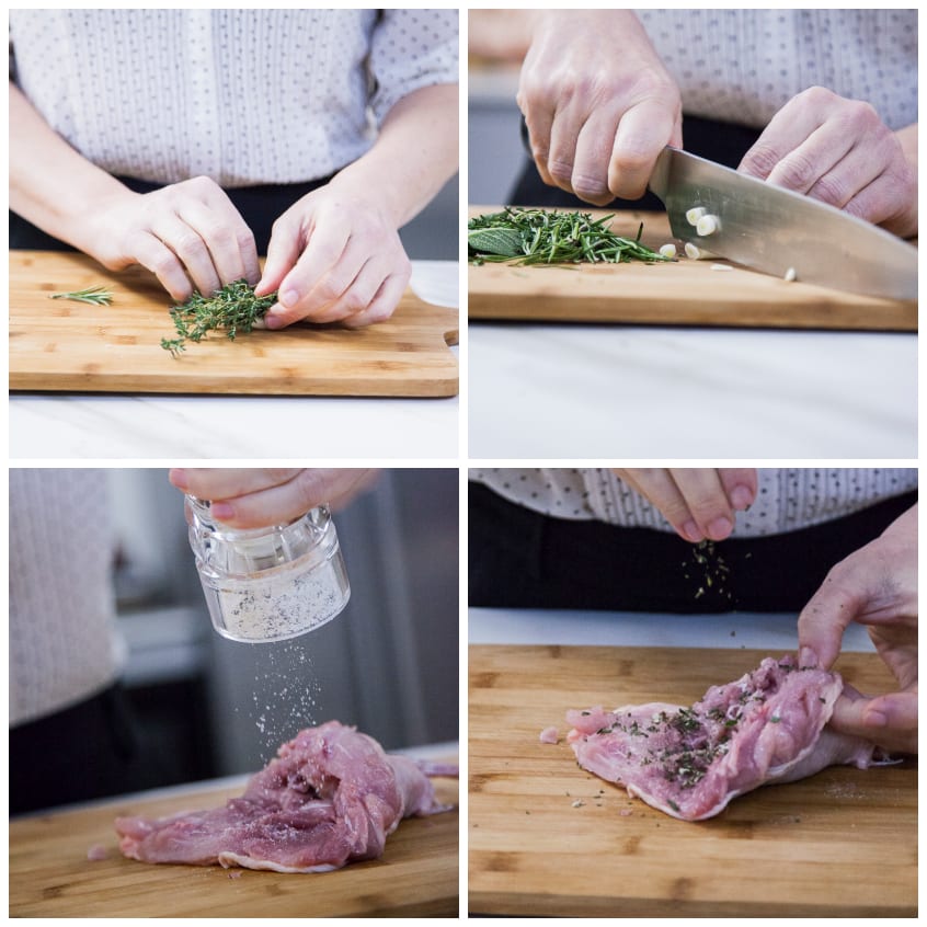 Mani che triturano erbe aromatiche e condiscono il jambonet di pollo aperto sul tagliere
