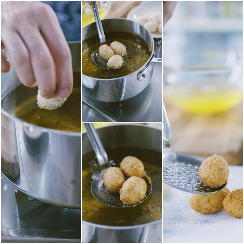 Olive ascolane impanate tuffate nell'olio caldo, scolate con il mestolo forato e poggiate su carta assorbente