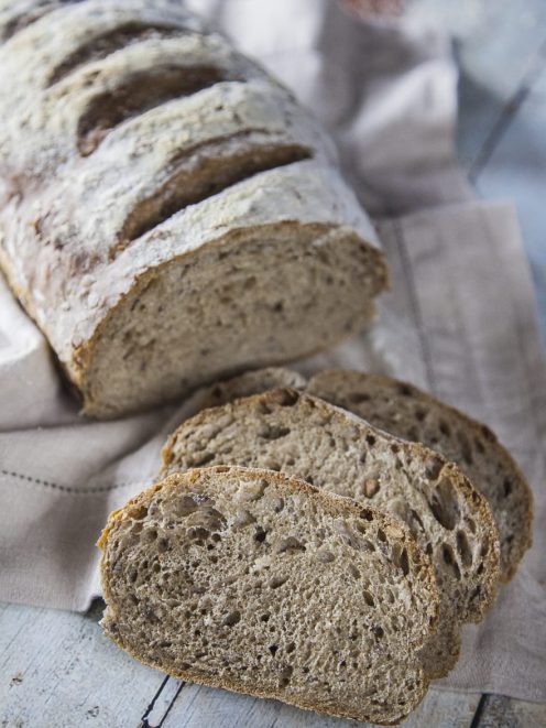 Pane multicereali affettato con mollica alveolata e crosta rustica infarinata