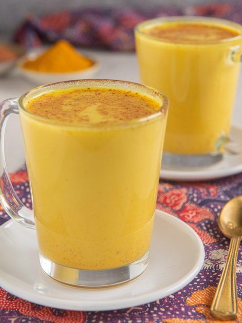 Golden milk con curcuma e cannella in polvere spolverata in superficie