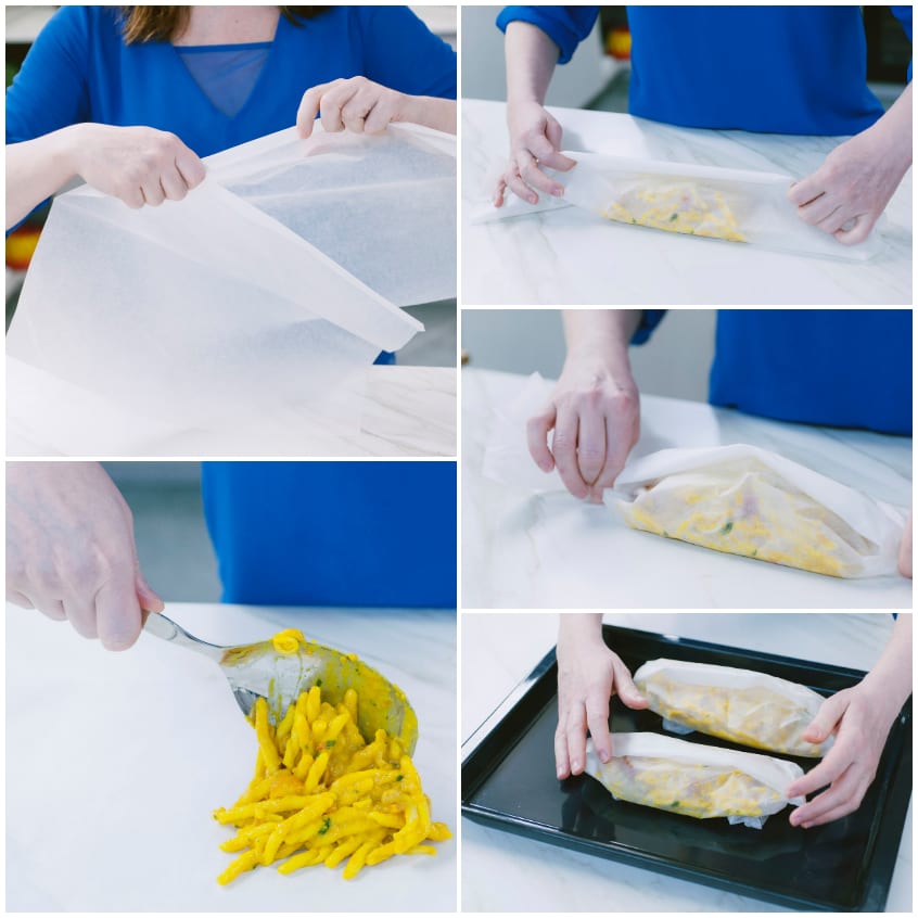 Strozzapreti allo zafferano disposti al centro della carta da forno e avvolti in cartocci individuali su teglia